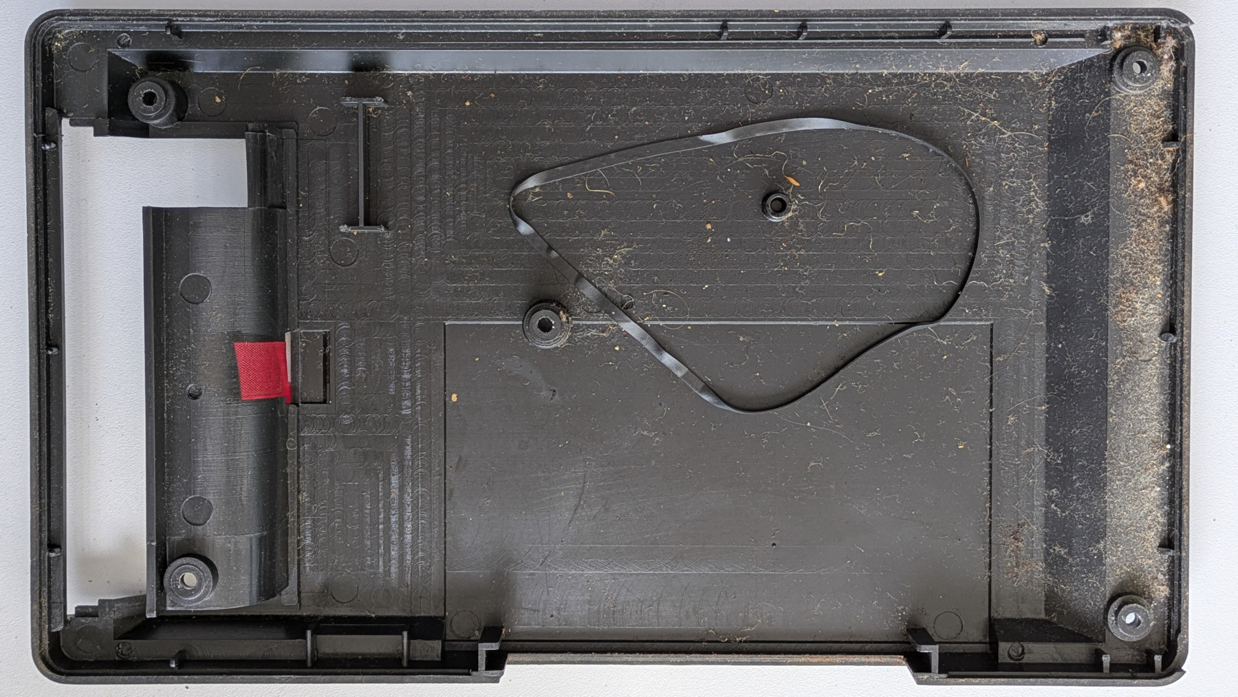 Cassette recorder case showing a rotten plastic belt
